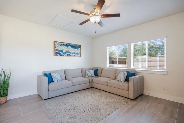 a living room with furniture and a large window
