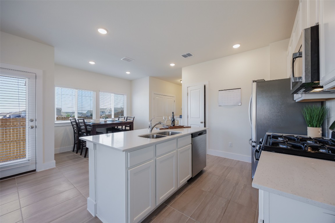 322 Furlong Drive Georgetown, TX 78626 - Photo 18 of 23 a kitchen with kitchen island a sink stove and refrigerator