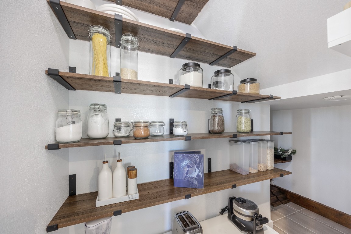 322 Furlong Drive Georgetown, TX 78626 - Photo 19 of 23 a kitchen with lots of stainless steel appliances a wooden table and chairs