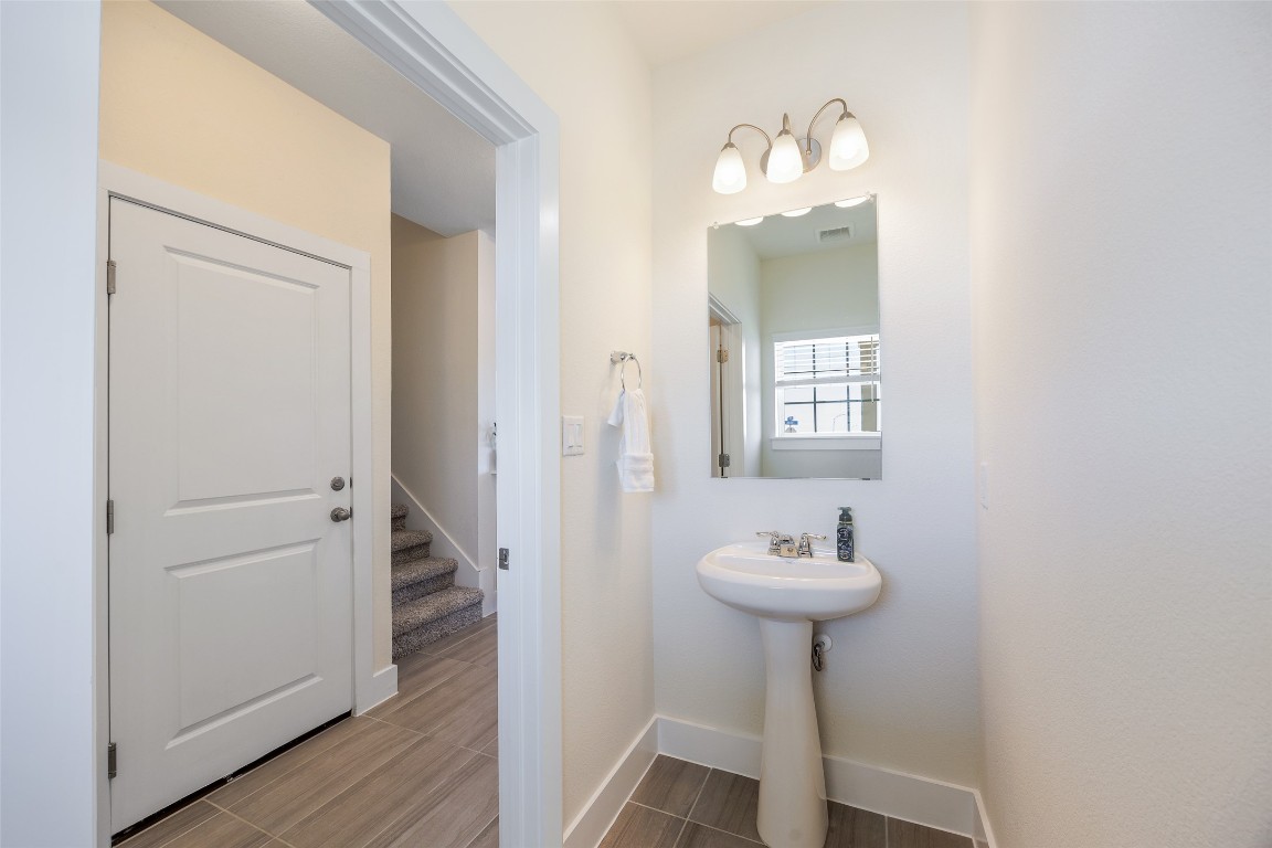 322 Furlong Drive Georgetown, TX 78626 - Photo 7 of 23 a bathroom with a sink a mirror and a window