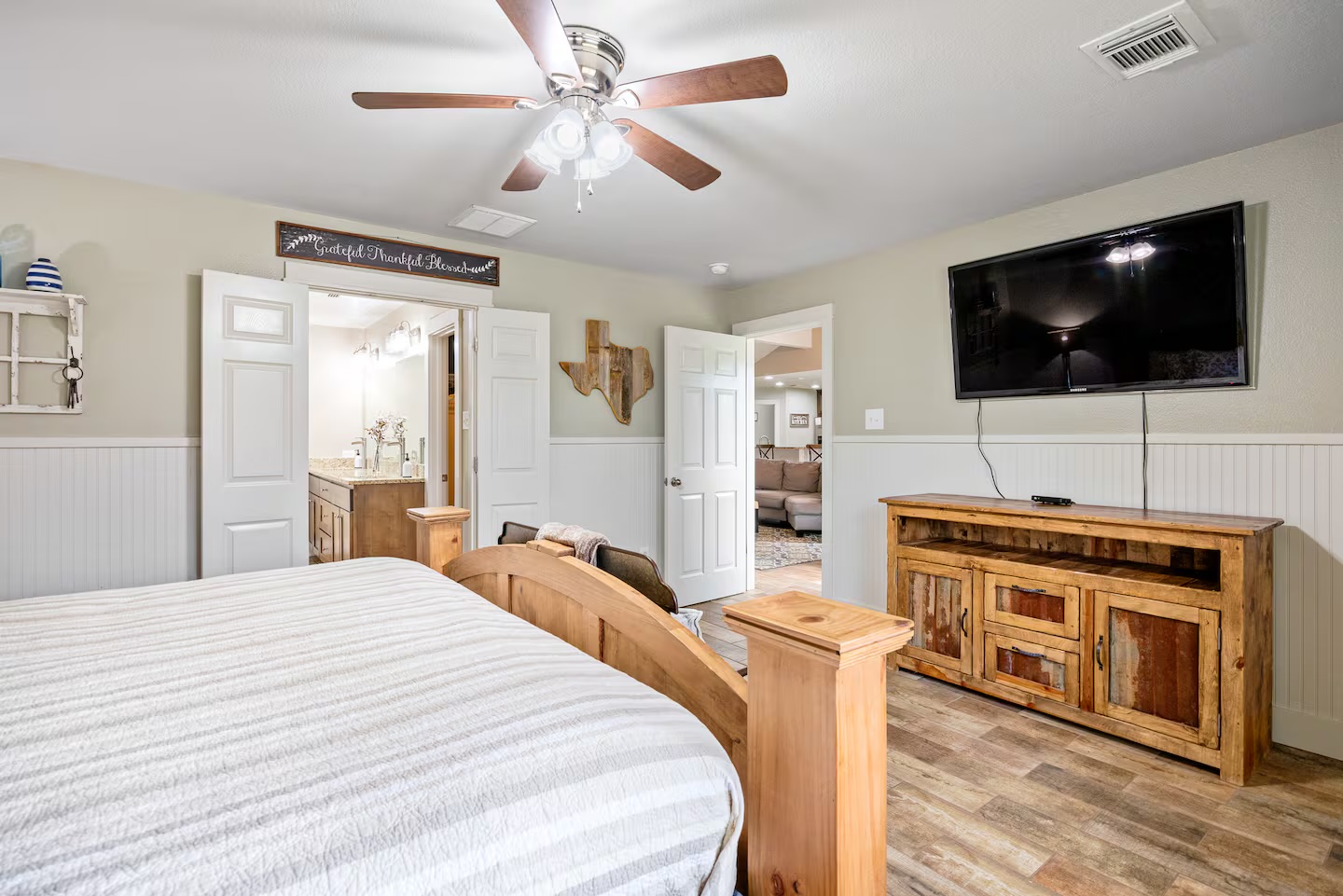 801 John Knox Road Fischer, TX 78623 - Photo 12 of 17 a bedroom with a bed and a flat screen tv