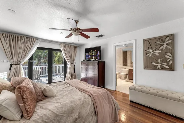 a bedroom with a large bed and a large window