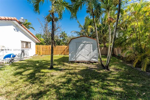 a backyard of a house with table and chairs