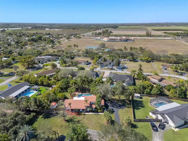 an aerial view of residential houses with outdoor space and ocean view