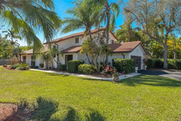 a view of a house with swimming pool and sitting area