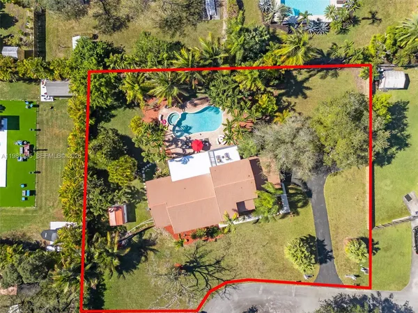 an aerial view of a house with a yard and garden