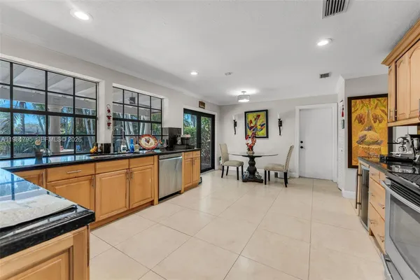 a kitchen with stainless steel appliances granite countertop a stove and a sink
