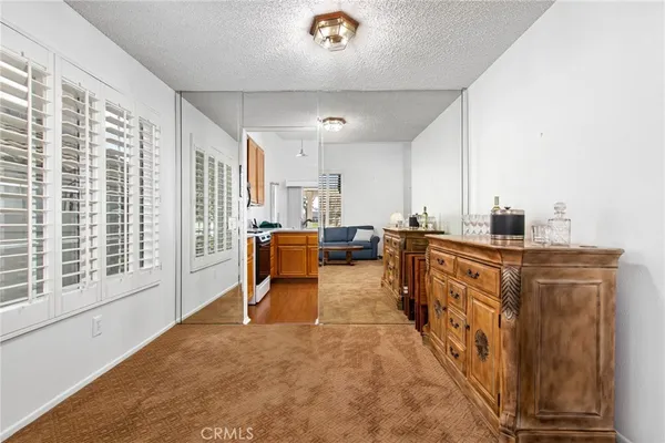 a large white kitchen with sink and breakfast area