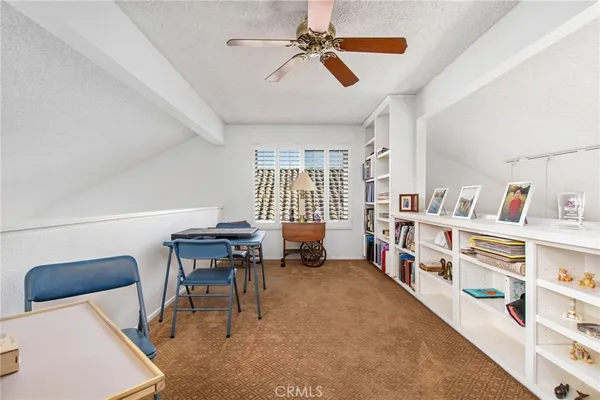 a reading room with furniture and a book shelf
