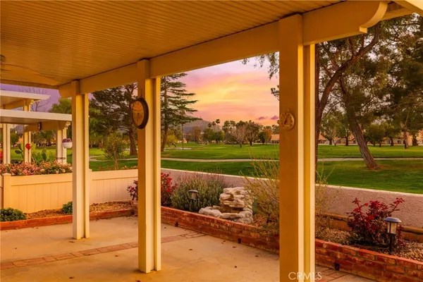 a view of a porch with a floor to ceiling window next to a yard