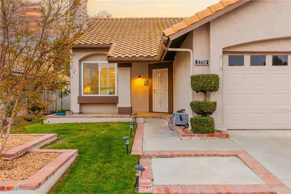 a view of a house with yard and tree s