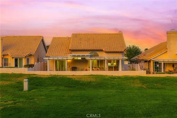 an aerial view of residential houses with outdoor space and ocean view