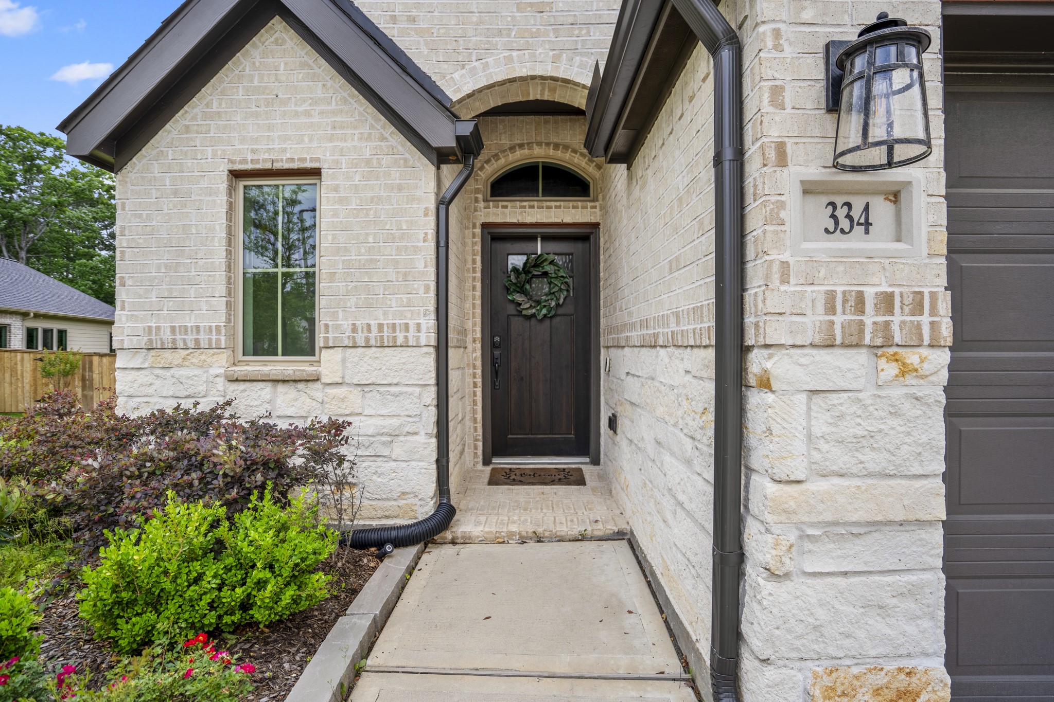 334 Topper Pines Drive Montgomery, TX 77316 - Photo 2 of 49 The gorgeous dark wood-stained front door stands out as a welcoming beacon among the neutral brick and stone of the home and is crowned by an arched transom window above.