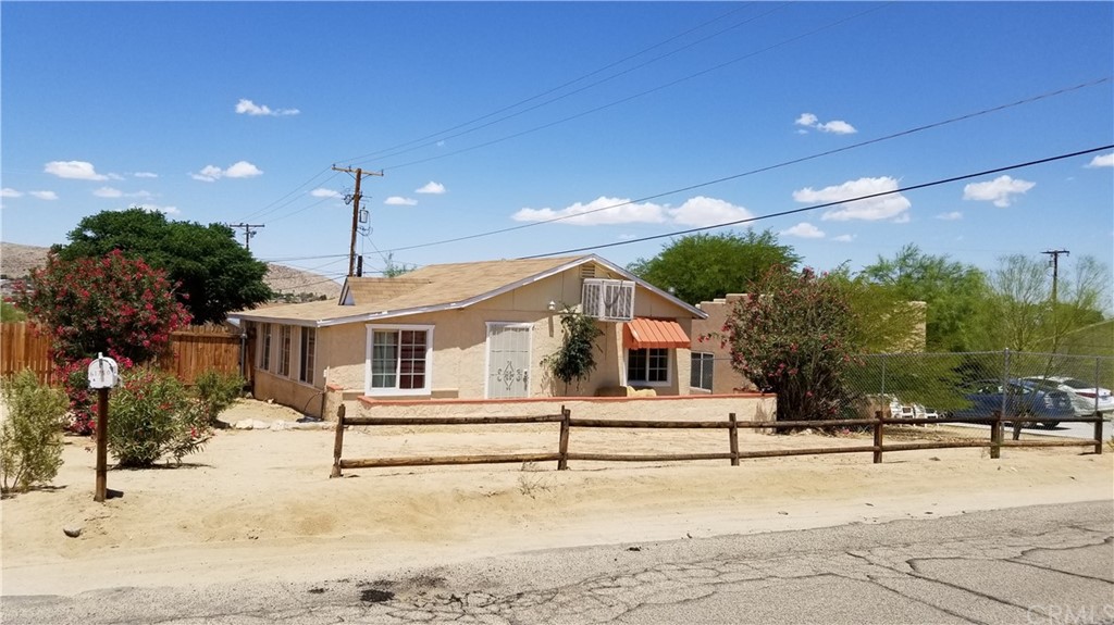 61750 Desert Air Road Joshua Tree, CA 92252 - Photo 2 of 28 a view of a house with a snow in the yard