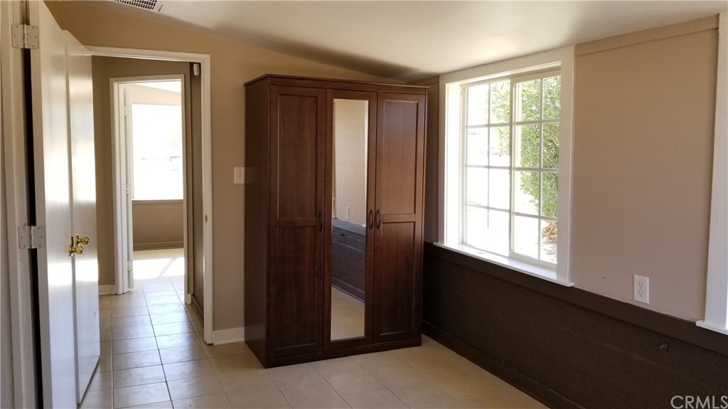 61750 Desert Air Road Joshua Tree, CA 92252 - Photo 13 of 28 a bed sitting in a bedroom next to a window