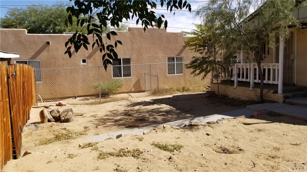 61750 Desert Air Road Joshua Tree, CA 92252 - Photo 17 of 28 a view of a chair and tables in the patio