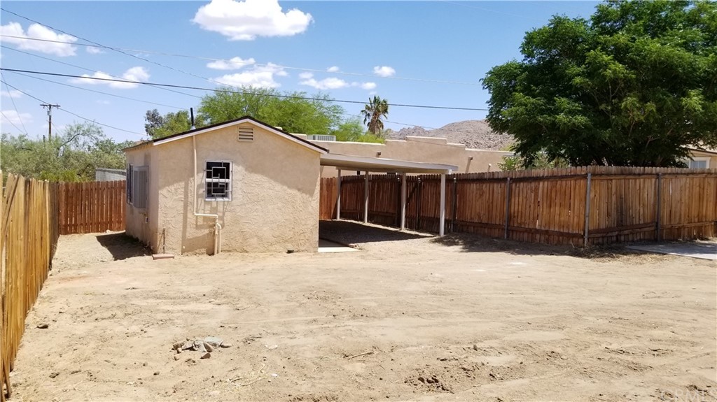 61750 Desert Air Road Joshua Tree, CA 92252 - Photo 22 of 28 a view of backyard of the house