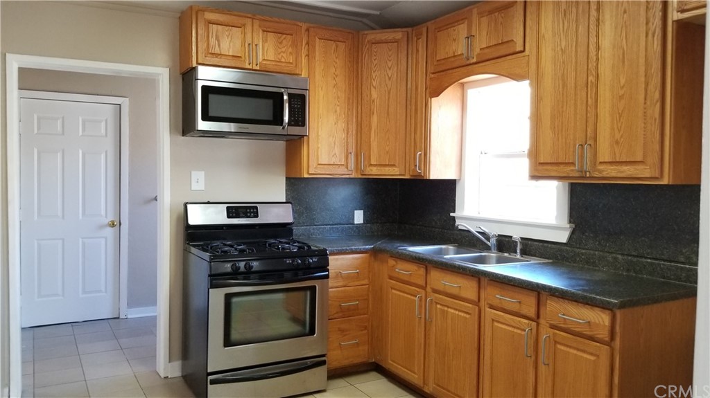 61750 Desert Air Road Joshua Tree, CA 92252 - Photo 7 of 28 a living room with furniture and a flat screen tv