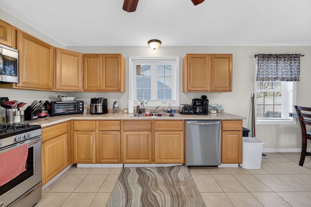 321 King Street Fall River, MA 02724 - Photo 11 of 40 a kitchen with a refrigerator sink and cabinets