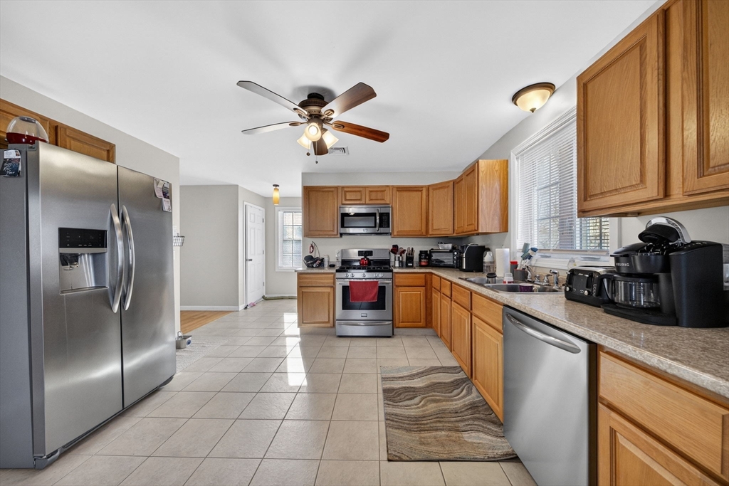 321 King Street Fall River, MA 02724 - Photo 12 of 40 a large kitchen with stainless steel appliances kitchen island granite countertop a refrigerator a sink a stove top oven and a dishwasher