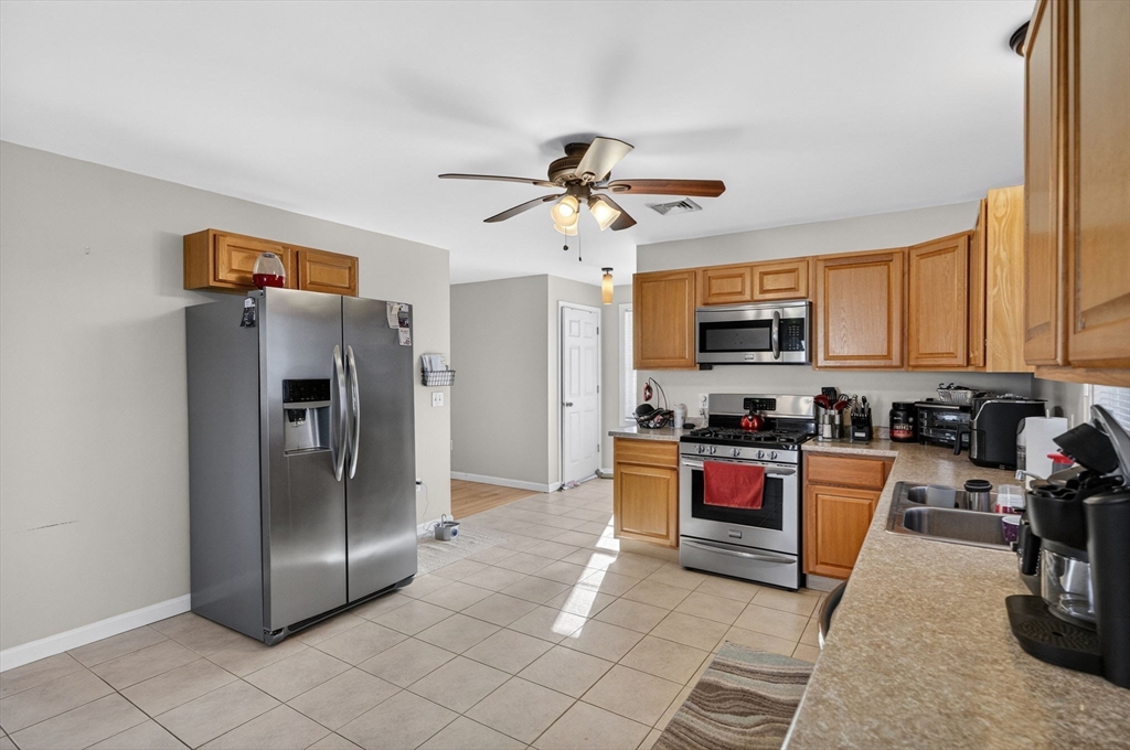 321 King Street Fall River, MA 02724 - Photo 13 of 40 a kitchen with stainless steel appliances granite countertop a refrigerator a stove top oven a sink and dishwasher