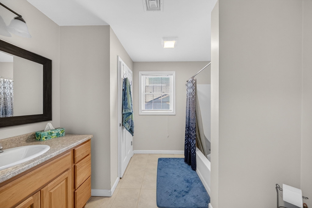 321 King Street Fall River, MA 02724 - Photo 17 of 40 a bathroom with a double vanity sink and mirror