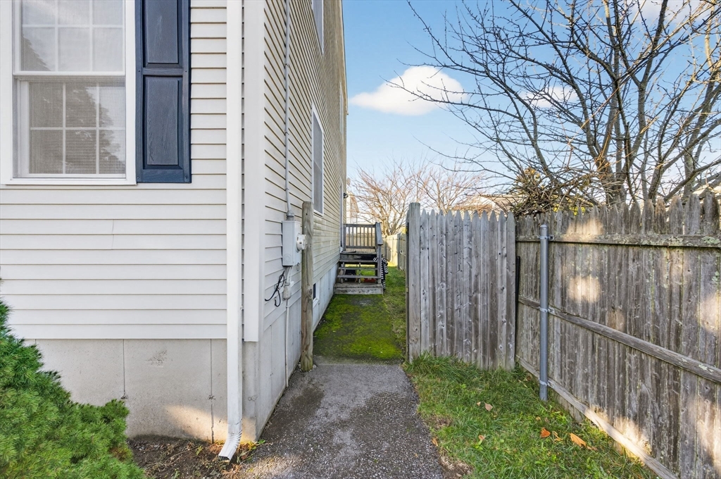 321 King Street Fall River, MA 02724 - Photo 5 of 40 a view of a pathway of a house with wooden fence