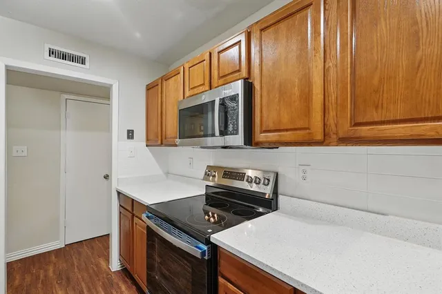 a kitchen with a stove microwave and sink