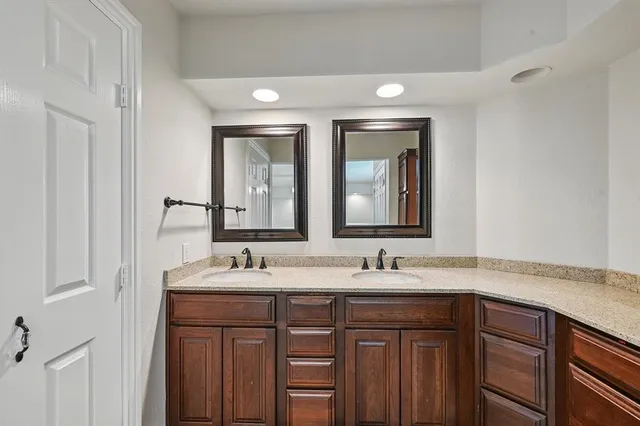 a bathroom with a double vanity sink and a mirror