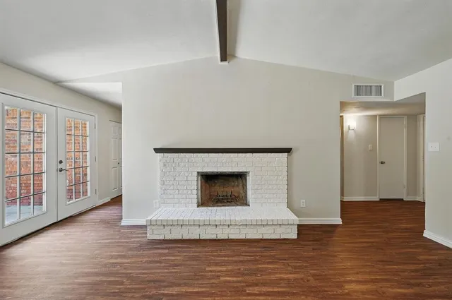 a view of a livingroom with a fireplace and window