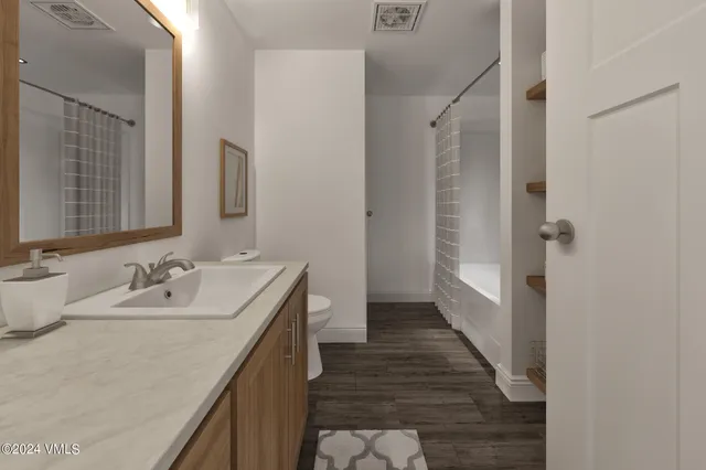 a bathroom with 2 sink and a mirror