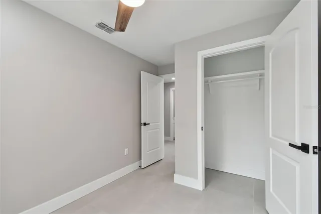 a bathroom with a toilet a sink a mirror and a window