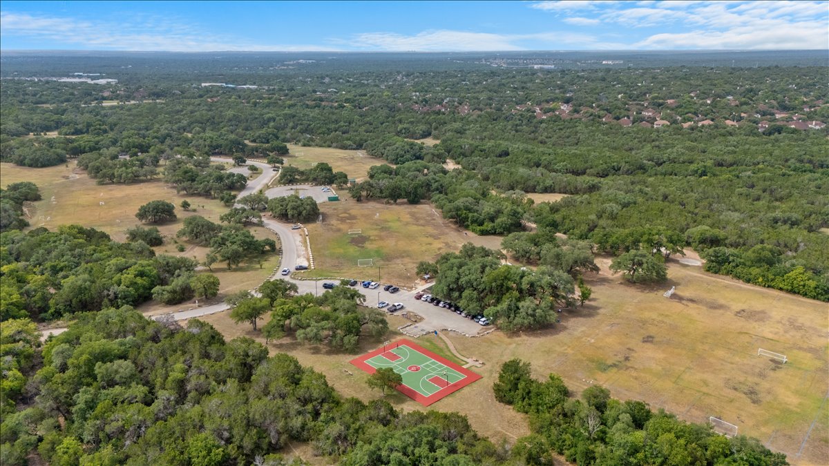 9012 Meacham Way Austin, TX 78749 - Photo 33 of 34 Expansive park-like grounds featuring a full basketball court, multiple sports fields, and a paved road with ample parking