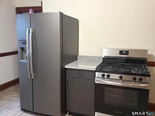 a stove top oven sitting inside of a kitchen