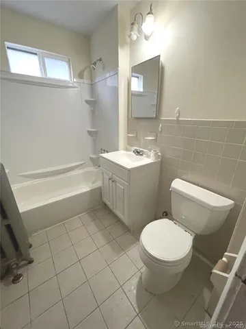 a bathroom with a toilet a sink and bathtub