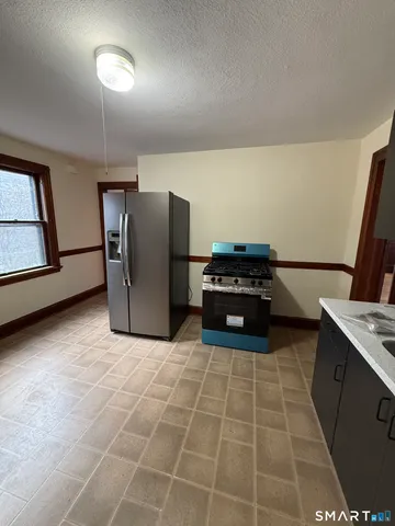 a kitchen with a refrigerator and a stove