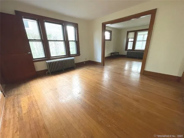 wooden floor in an empty room with a window