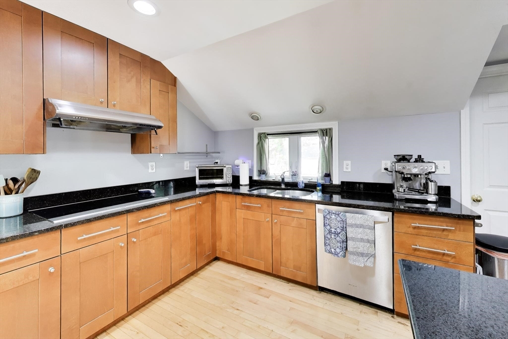 22 Douglas Road Ashland, MA 01721 - Photo 10 of 24 a kitchen with stainless steel appliances granite countertop a sink stove and cabinets