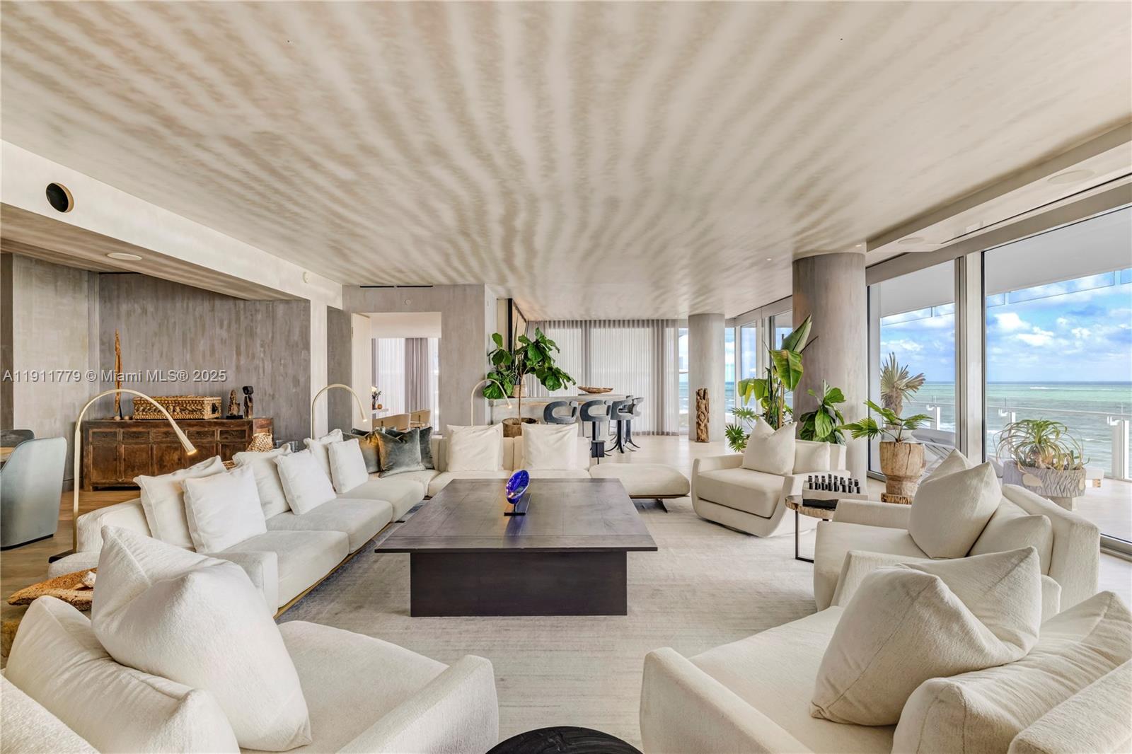 9111 Collins Avenue, Unit N721 Surfside, FL 33154 - Photo 2 of 52 a living room with furniture and a large window