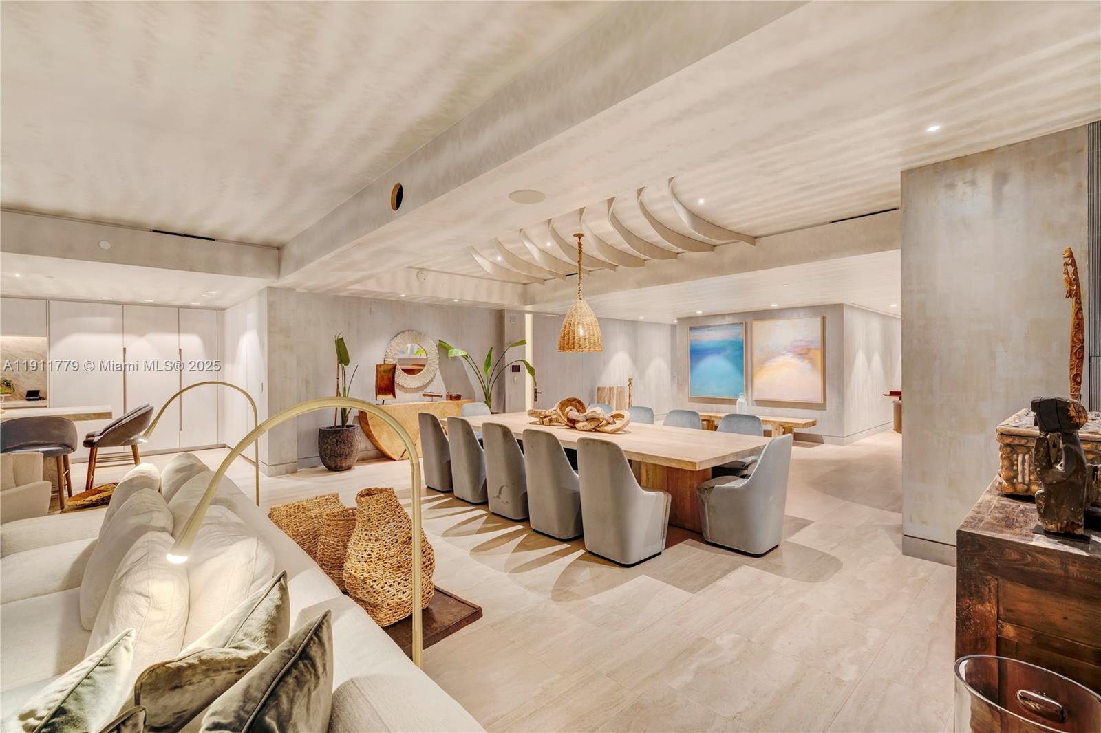 9111 Collins Avenue, Unit N721 Surfside, FL 33154 - Photo 21 of 52 a view of a dining room with furniture a kitchen and chandelier