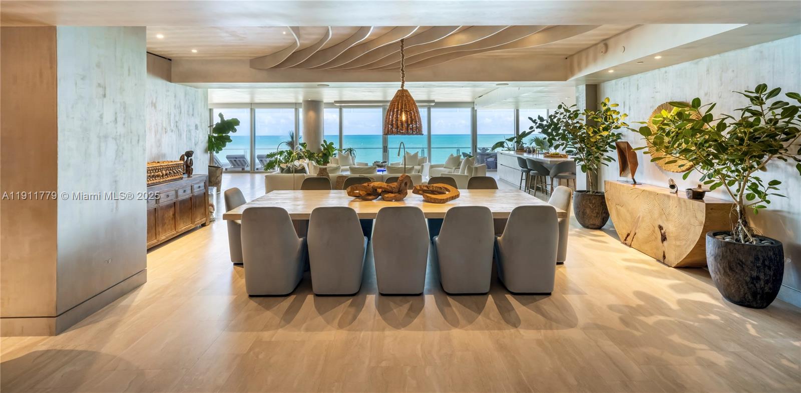9111 Collins Avenue, Unit N721 Surfside, FL 33154 - Photo 29 of 52 a dining room with furniture and a potted plant