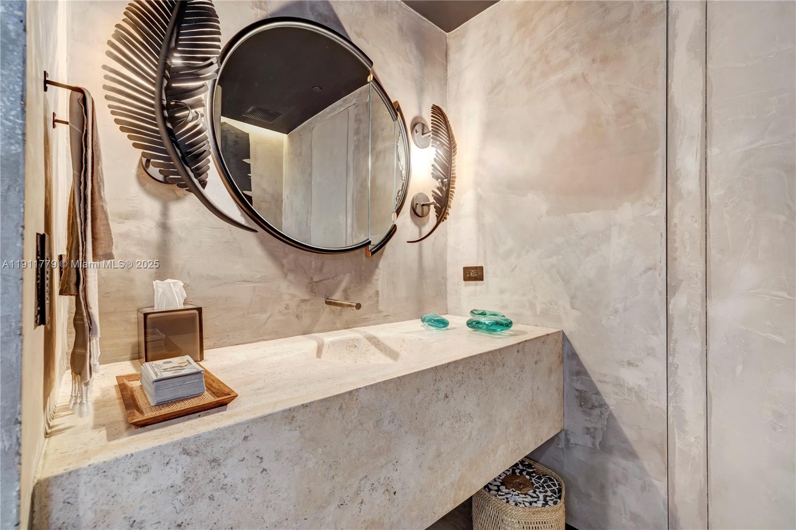 9111 Collins Avenue, Unit N721 Surfside, FL 33154 - Photo 52 of 52 a bathroom with a sink and a mirror