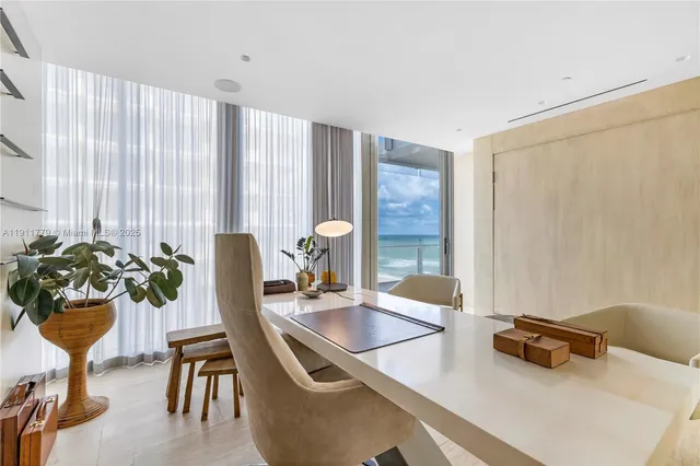 a dining room with furniture and floor to ceiling window