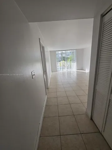 a view of a livingroom with wooden floor and a window
