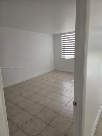 a view of an empty room and a window