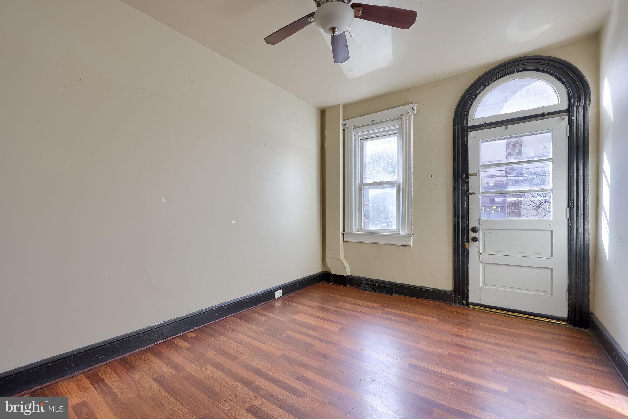 519 South Prince Street Lancaster, PA 17603 - Photo 6 of 15 an empty room with wooden floor fan and windows