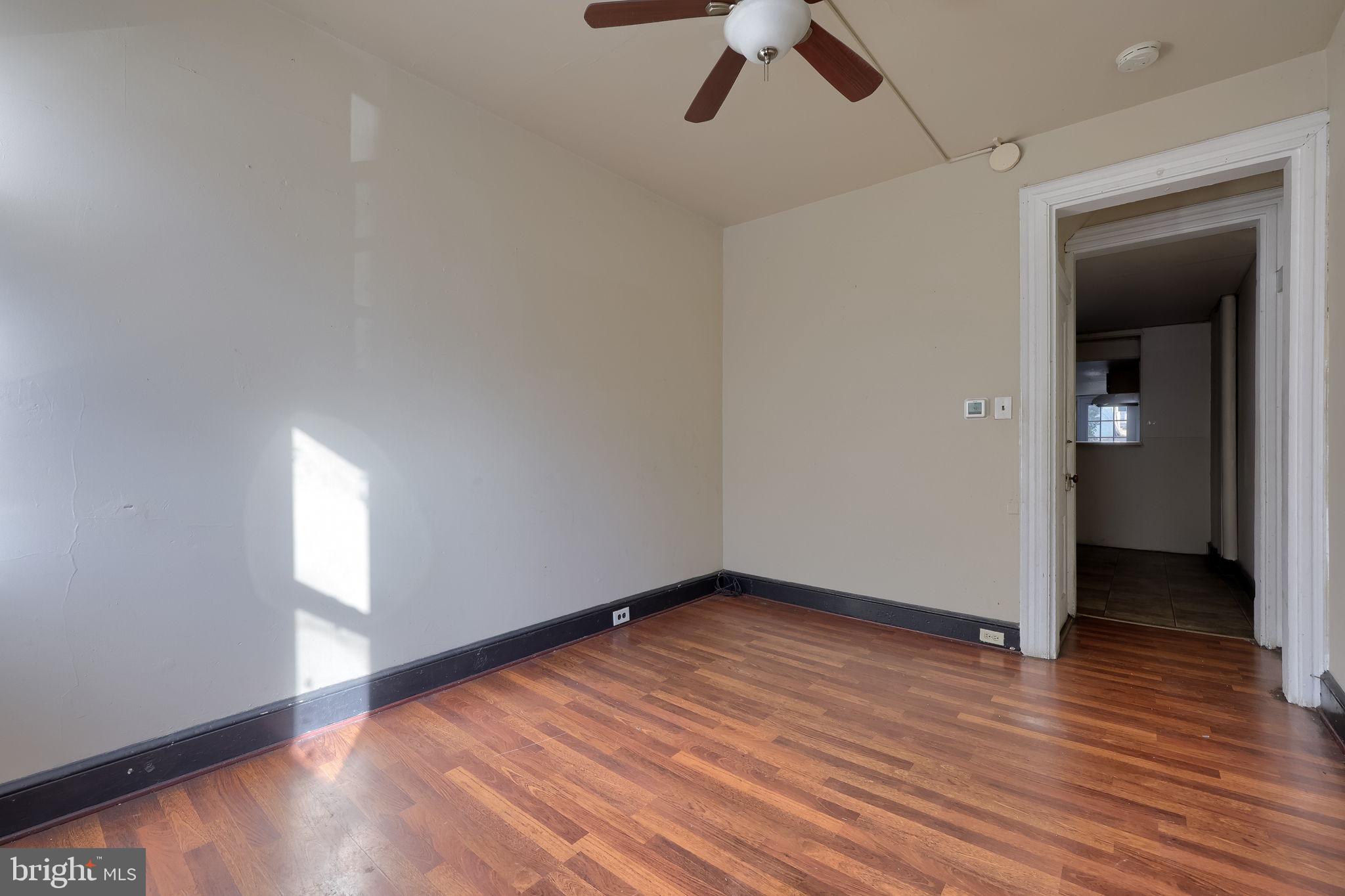 519 South Prince Street Lancaster, PA 17603 - Photo 7 of 15 an empty room with wooden floor cabinet and windows