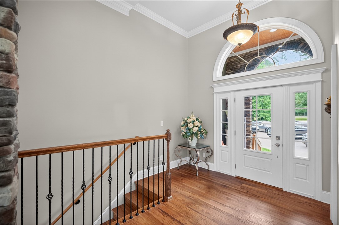 206 James Hare Road Anderson, SC 29626 - Photo 36 of 37 A grand entrance welcomes guests with polished hardwood floors and a striking arched transom window above the front door.