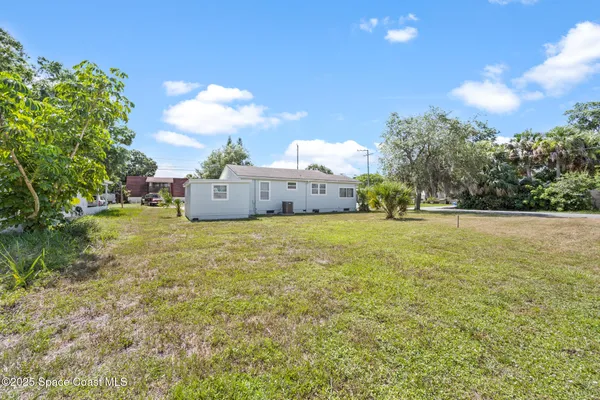 a front view of a house with a garden and yard