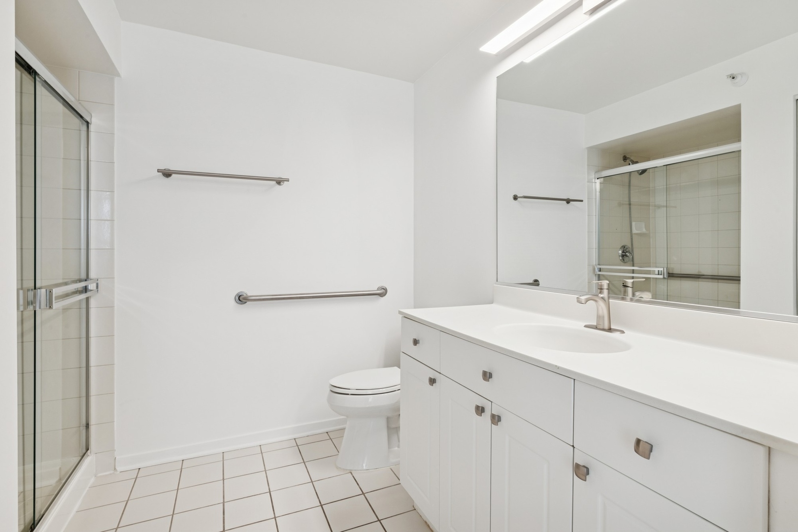 1640 Maple Avenue, Unit 1202 Evanston, IL 60201 - Photo 12 of 19 a bathroom with a toilet a sink and mirror
